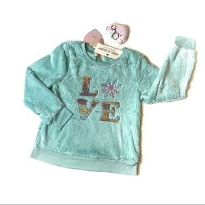 Between NWT fuzzy top with sequins appliqué